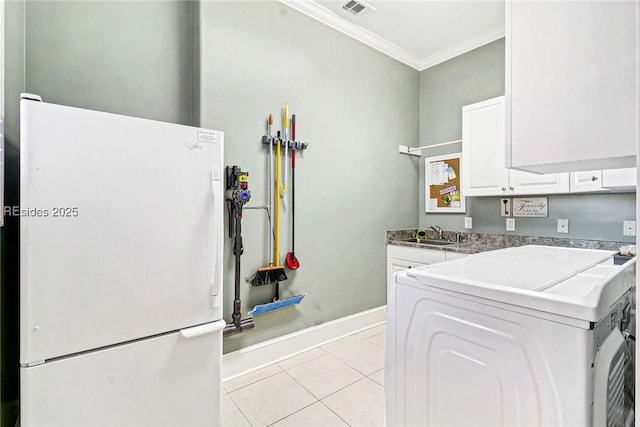 laundry area with sink, light tile patterned floors, cabinets, ornamental molding, and washer / clothes dryer