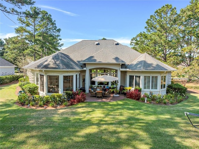 back of house with a patio and a yard