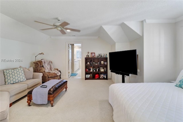 carpeted bedroom with lofted ceiling, connected bathroom, crown molding, a textured ceiling, and ceiling fan