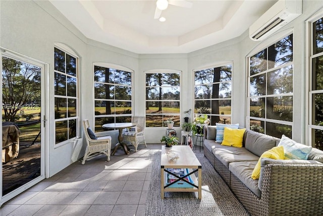 sunroom featuring ceiling fan, a raised ceiling, and a wall mounted AC