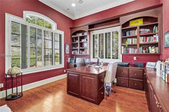 office with ornamental molding, hardwood / wood-style floors, and a wealth of natural light