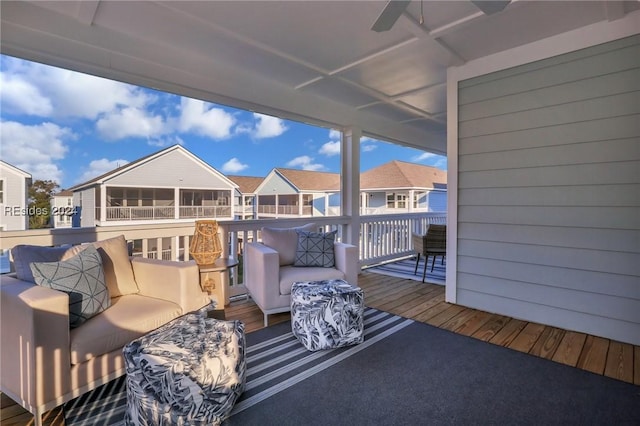 wooden terrace featuring ceiling fan and an outdoor living space