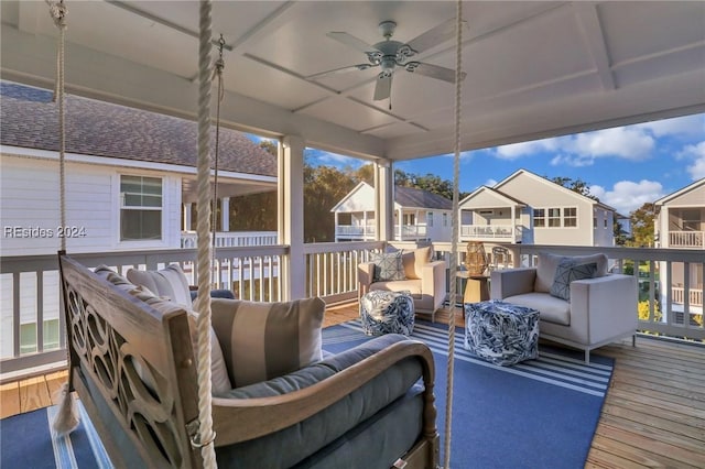 wooden deck featuring an outdoor living space and ceiling fan