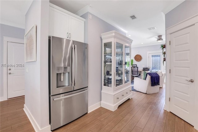 kitchen featuring white cabinetry, stainless steel fridge, ceiling fan, and light hardwood / wood-style flooring