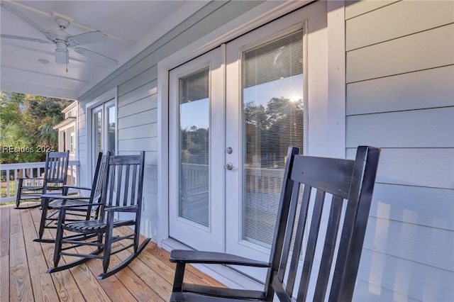 deck with ceiling fan and a porch