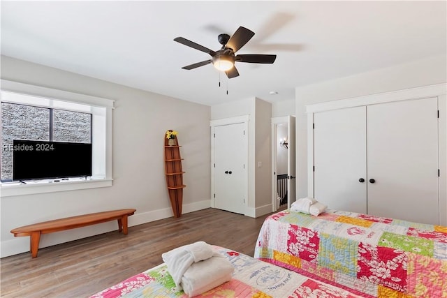 bedroom featuring hardwood / wood-style flooring, ceiling fan, and a closet