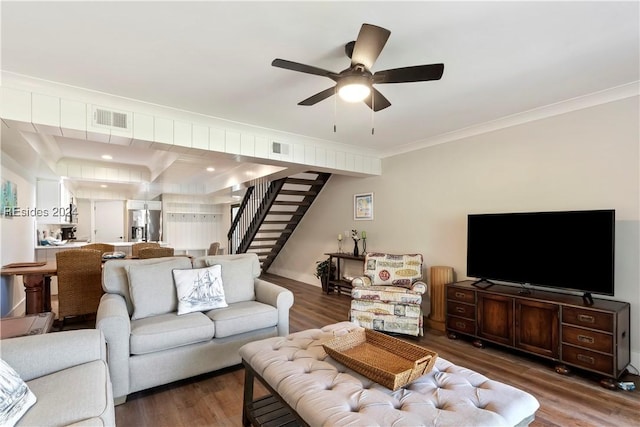 living room with ornamental molding, dark hardwood / wood-style floors, and ceiling fan