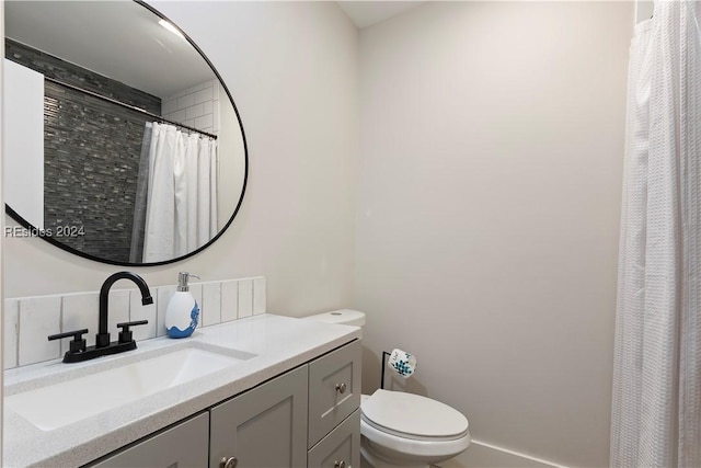 bathroom with vanity, a shower with shower curtain, and toilet