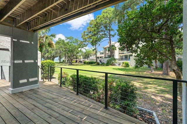 wooden terrace featuring a lawn