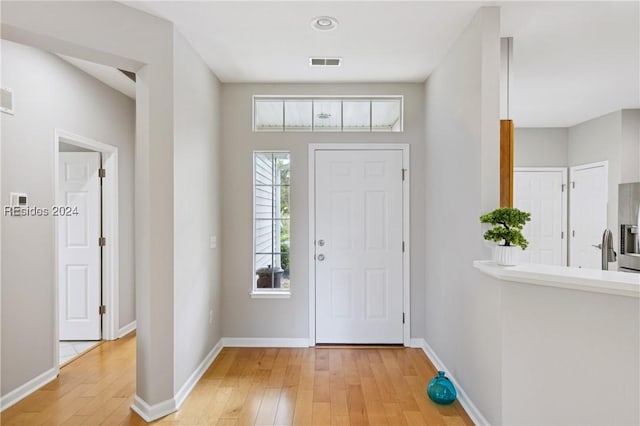 foyer entrance with light hardwood / wood-style flooring