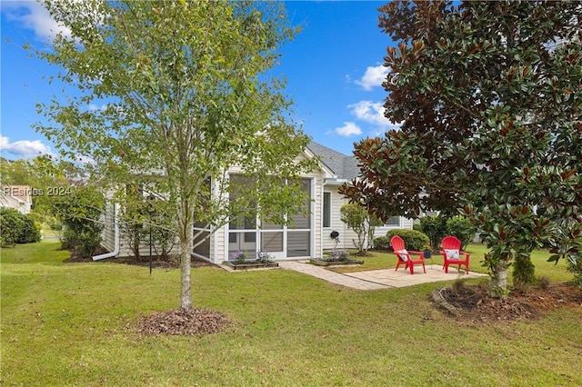 view of yard with a sunroom and a patio area