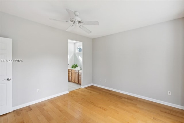 unfurnished room with ceiling fan and light hardwood / wood-style flooring