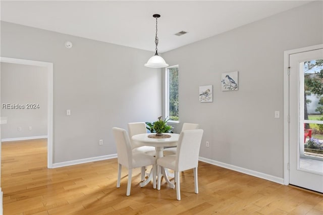 dining space with light hardwood / wood-style floors