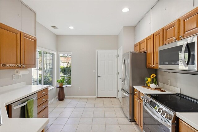 kitchen featuring light tile patterned floors and stainless steel appliances