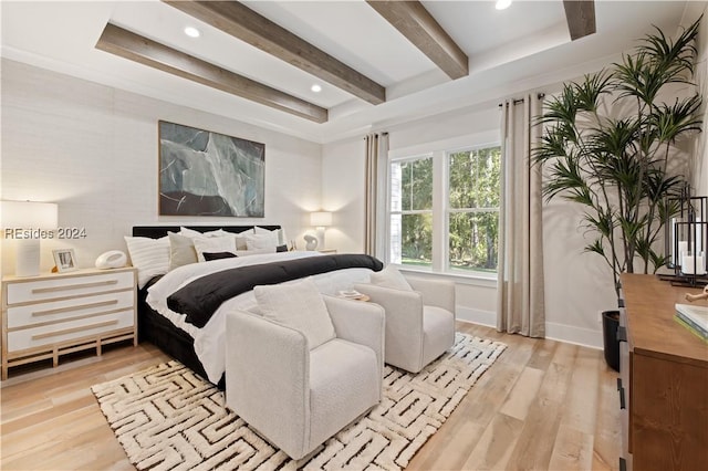 bedroom featuring light hardwood / wood-style flooring and beamed ceiling