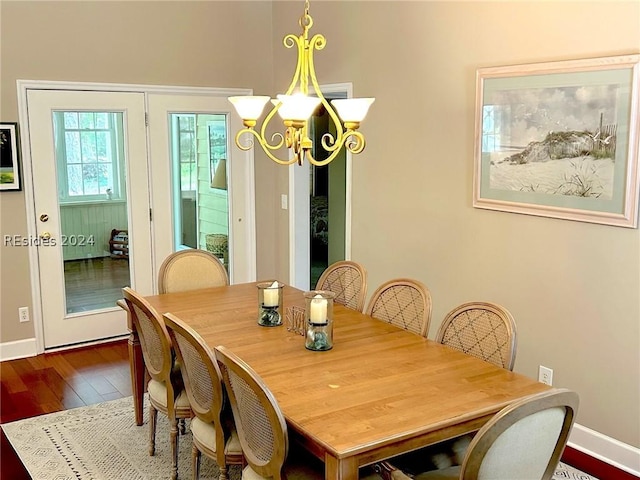 dining room featuring a notable chandelier and hardwood / wood-style flooring