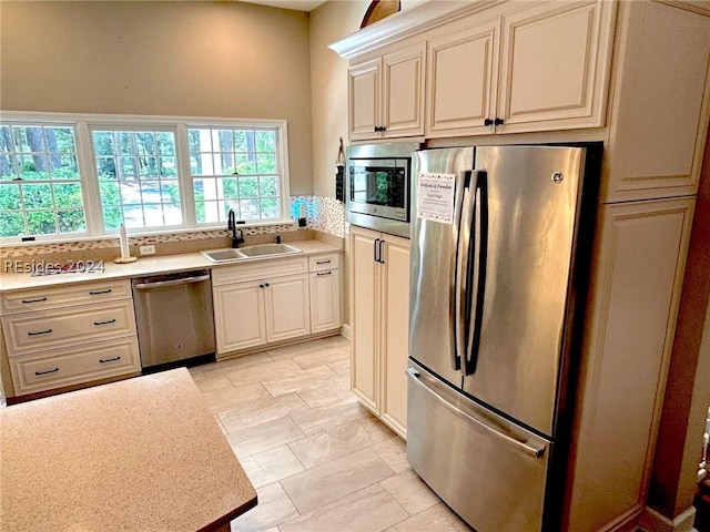 kitchen with stainless steel appliances, tasteful backsplash, and sink