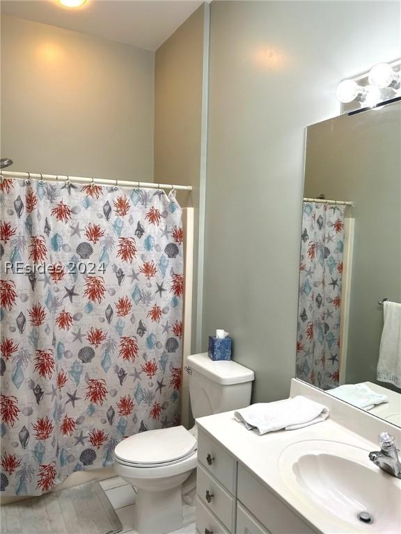 bathroom with vanity, tile patterned floors, and toilet