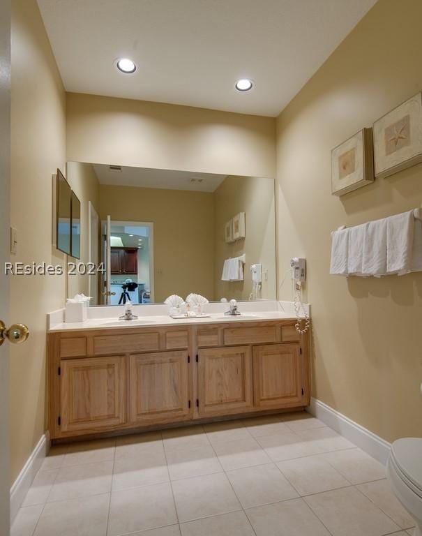 bathroom with tile patterned flooring, vanity, and toilet