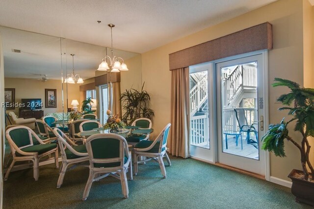 carpeted dining space featuring an inviting chandelier