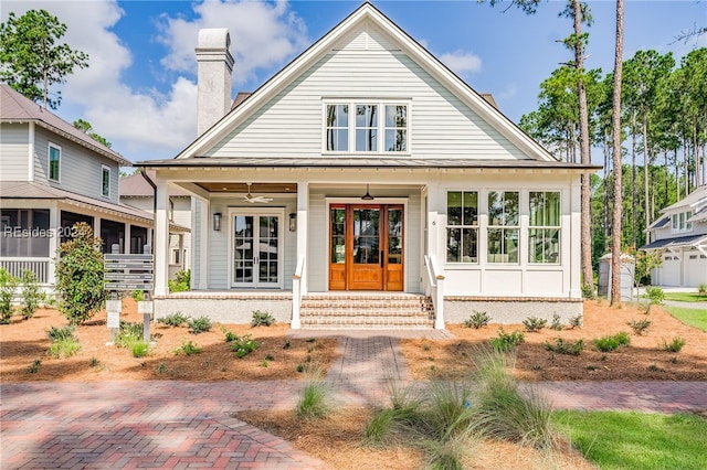 view of front of house featuring ceiling fan and french doors