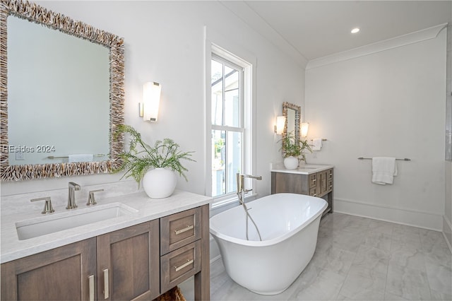 bathroom featuring crown molding, a washtub, and vanity