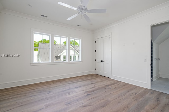 empty room with crown molding, ceiling fan, and light hardwood / wood-style flooring