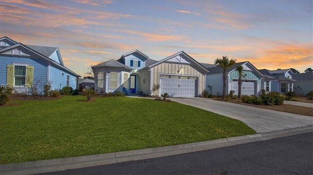 view of front of property with a garage and a lawn