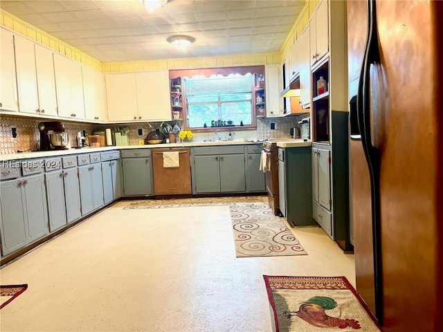 kitchen with appliances with stainless steel finishes, tasteful backsplash, white cabinetry, sink, and gray cabinetry