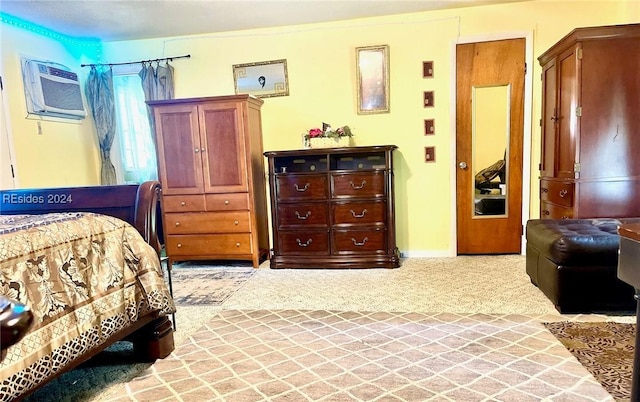 bedroom featuring light colored carpet and a wall mounted AC