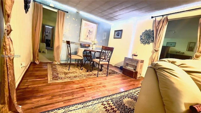 dining area with dark wood-type flooring and ornamental molding