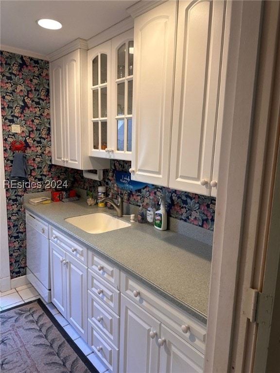 kitchen with white cabinetry, dishwasher, sink, and light tile patterned floors