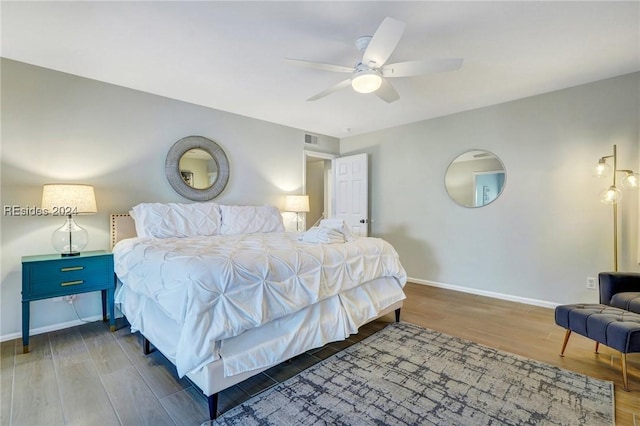 bedroom featuring hardwood / wood-style flooring and ceiling fan