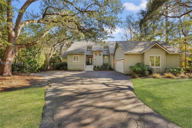 view of front of property with a garage and a front lawn