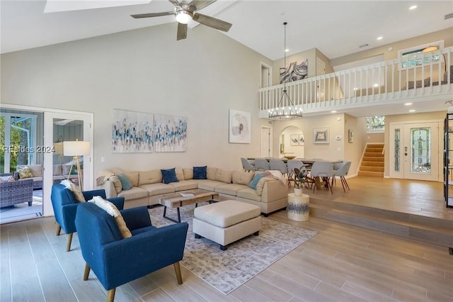 living room with wood-type flooring, a wealth of natural light, and high vaulted ceiling