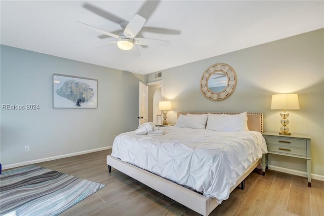 bedroom with hardwood / wood-style flooring and ceiling fan