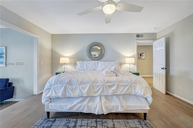 bedroom with ceiling fan and light hardwood / wood-style flooring