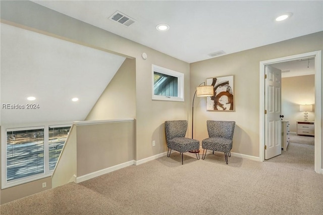 sitting room featuring a healthy amount of sunlight and light carpet