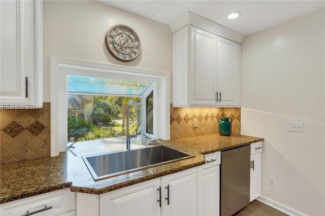 kitchen featuring white cabinetry, dishwasher, sink, and decorative backsplash