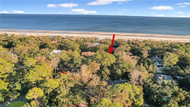 drone / aerial view featuring a water view and a view of the beach