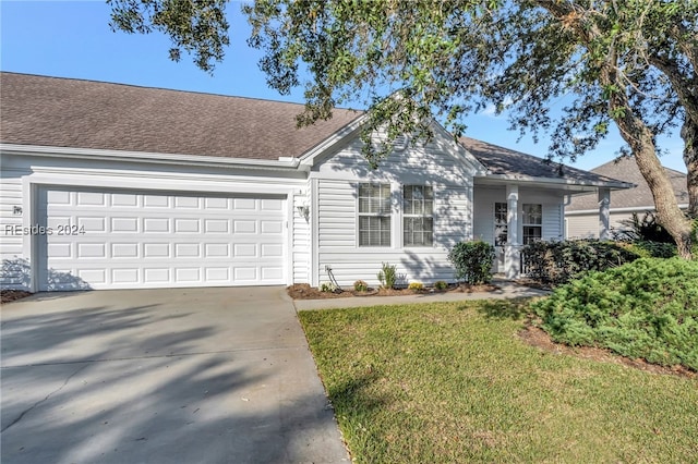 single story home featuring a garage and a front lawn