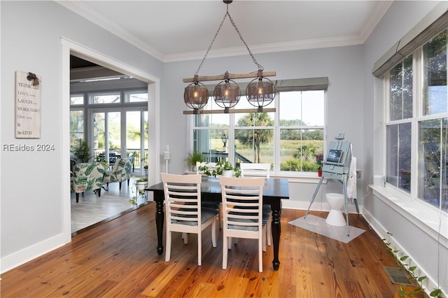 dining space with crown molding and wood-type flooring