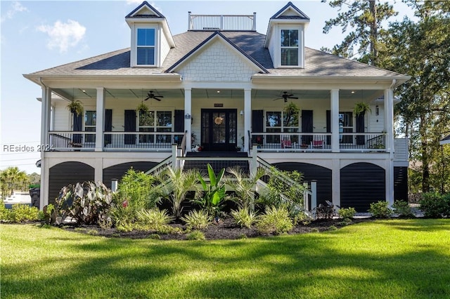 rear view of property featuring a lawn, ceiling fan, and a porch