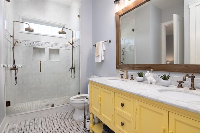 bathroom featuring vanity, a shower with door, and toilet