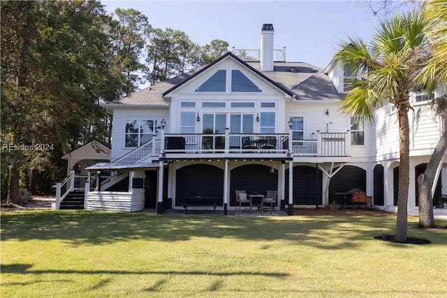 rear view of house with a wooden deck and a yard