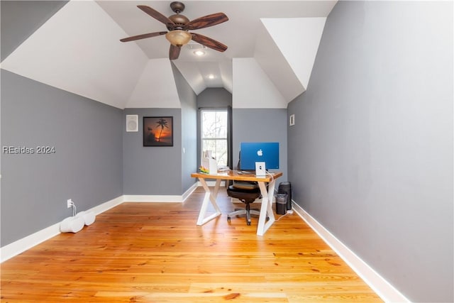 home office featuring vaulted ceiling, ceiling fan, and light wood-type flooring