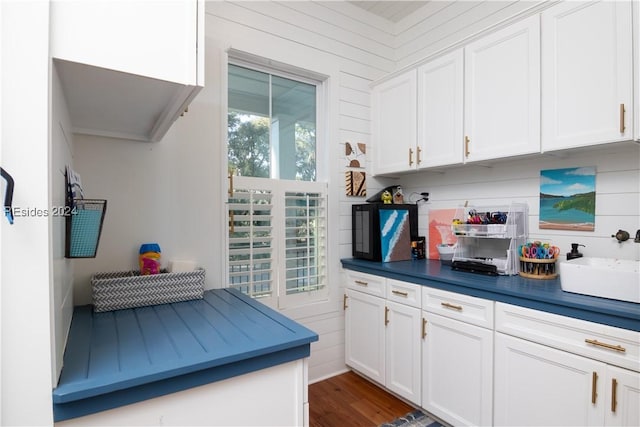 kitchen featuring white cabinetry, sink, and dark hardwood / wood-style flooring