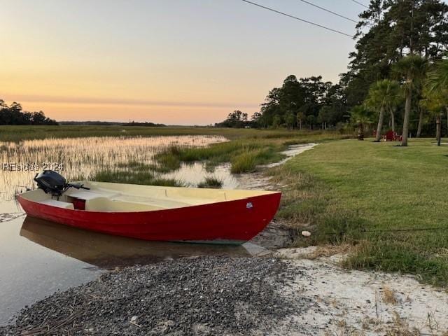 surrounding community with a yard and a water view