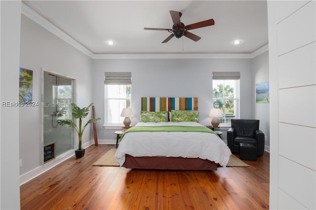 bedroom featuring hardwood / wood-style flooring, ceiling fan, ornamental molding, and multiple windows