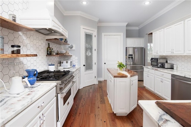 kitchen featuring white cabinetry, appliances with stainless steel finishes, light stone countertops, and backsplash